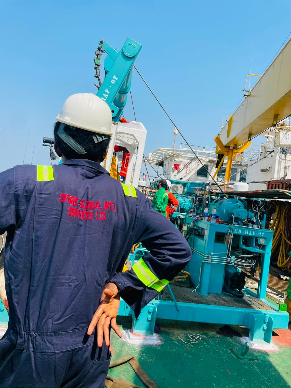 OGIS-branded field personnel standing on the deck of a marine vessel