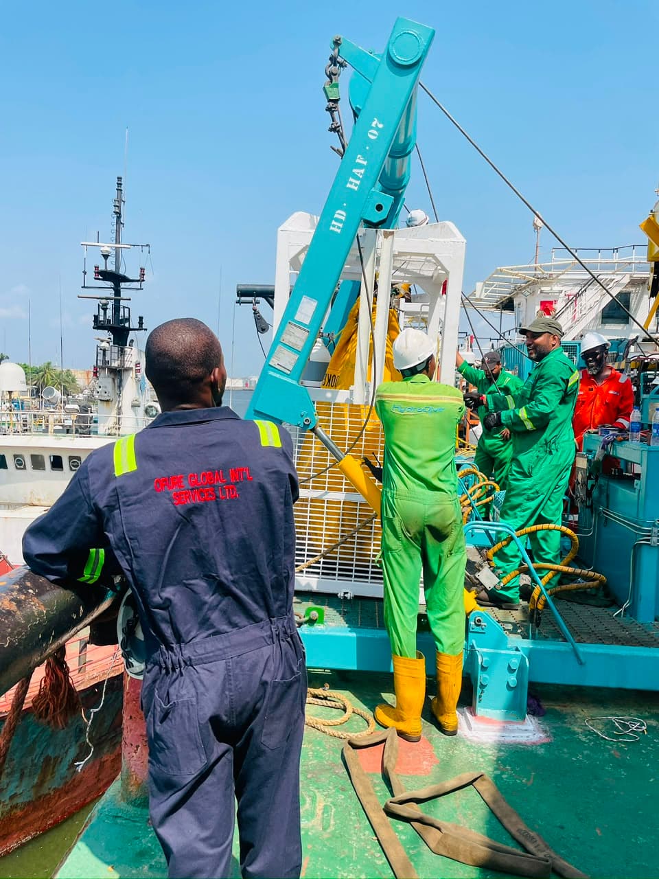 OGIS personnel and other crew members working around equipment on a vessel deck